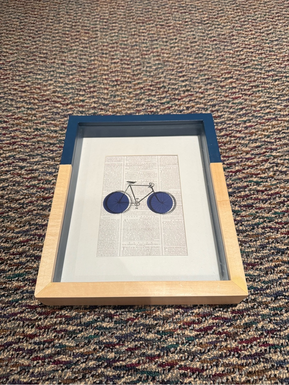 Vintage painted bike in front of newspaper framed